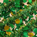 Hongsome 50 feet festive Irish garland wrapped beautifully around a dark wooden staircase banister.