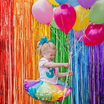 LOLStar photo booth prop background with a person posing against the bright shiny tinsel strands