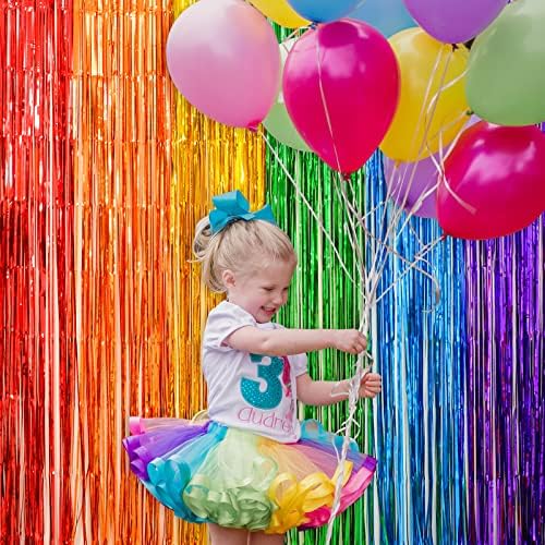 LOLStar photo booth prop background with a person posing against the bright shiny tinsel strands