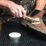 Otter Wax Saddle Soap applied to a leather boot with a cleaning brush