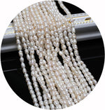 Side angle view of small white cultured pearl beads