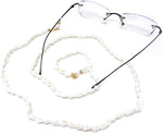 Close up of white conch shells and gold tone accents