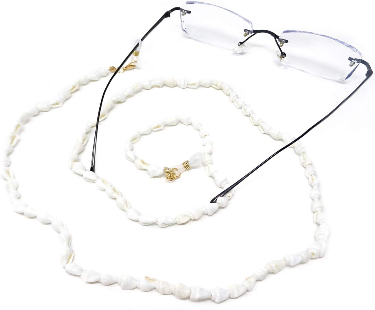 Close up of white conch shells and gold tone accents