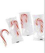 Generic holiday mini candy canes spread out to showcase the bulk quantity.