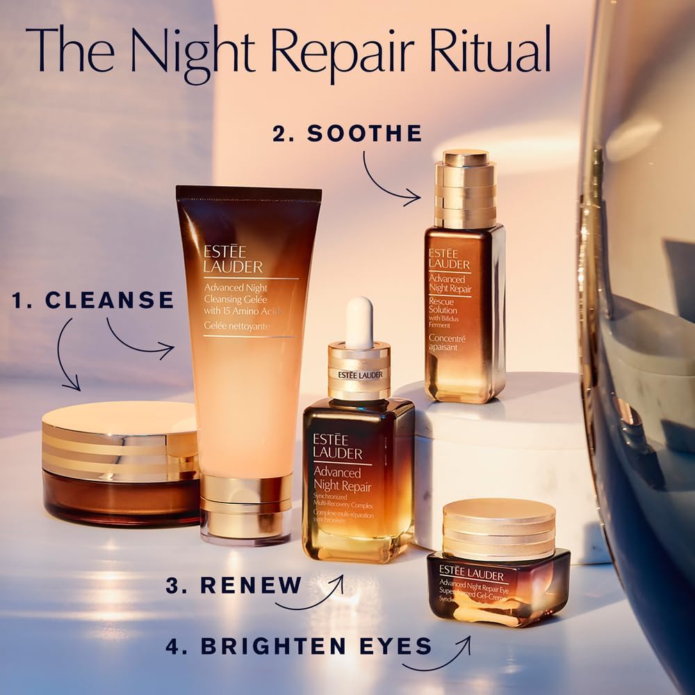 Estee Lauder luxury nighttime foaming cleanser bottle on a solid surface.