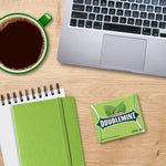 Green arrow branding on the packaging of Doublemint chewing gum packs close up.