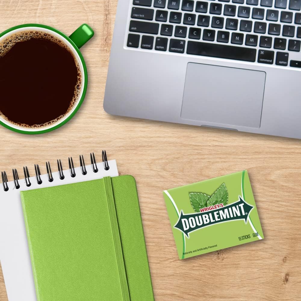 Green arrow branding on the packaging of Doublemint chewing gum packs close up.