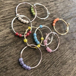 Hand model wearing OIDIMS thin coil stress relief ring set.
