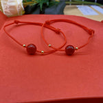 Model wrist wearing the ZMANYIJEW red string bracelet set