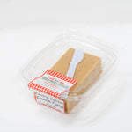 Speculoos spiced cookie dough layered fudge squares placed on a rustic wood board