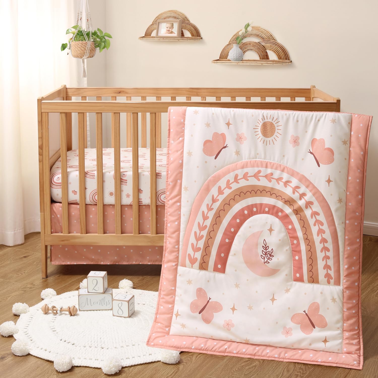 The Peanutshell Boho Rainbow 3 Piece Baby Crib Bedding Set front view featuring pink and coral comforter with fitted sheet