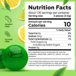 Assorted fruit flavored mini gumballs measuring 0.5 inches poured out on a white surface.