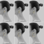 Gacimy lightweight gold hoops paired together on neutral display background