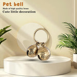 Extra loud copper pet pendant tracker attached to a green small dog collar.