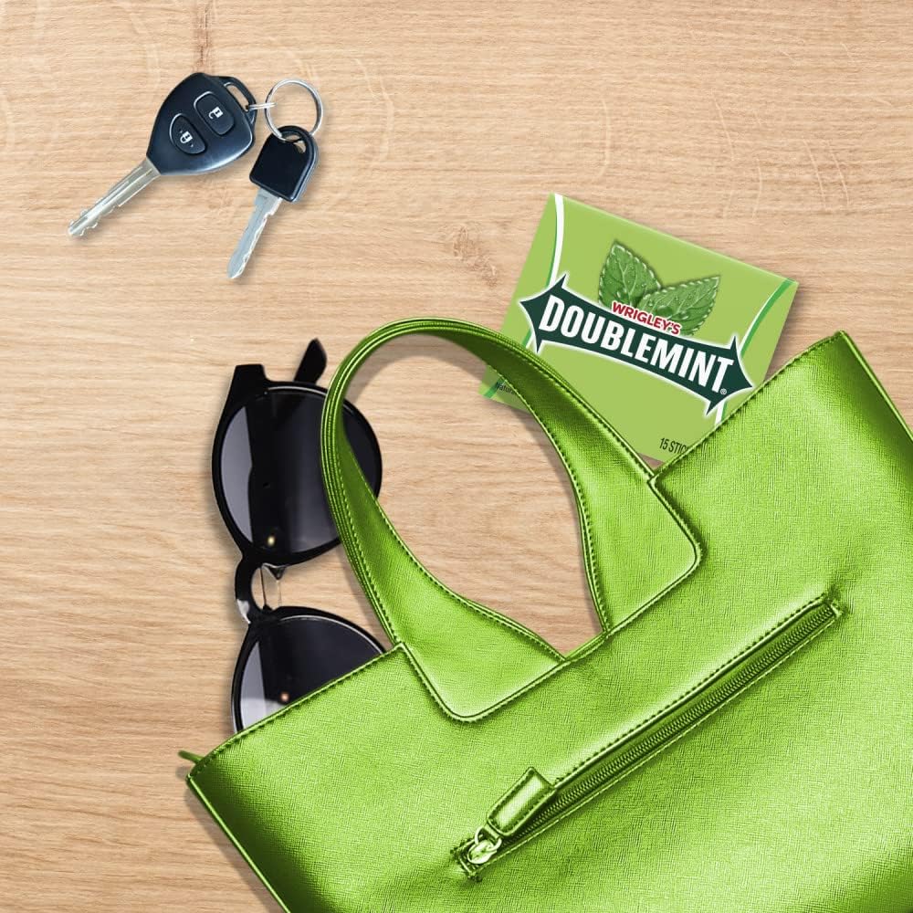 Person holding a pack of classic USA imported Doublemint chewing gum for fresh breath.