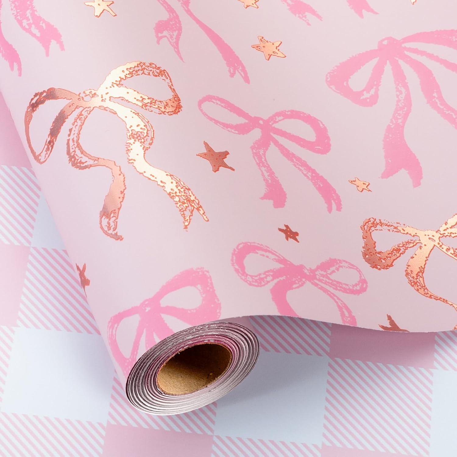 MAYPLUSS Pink Wrapping Paper Roll front view showing the metallic rose gold foil bow pattern on a premium paper roll.