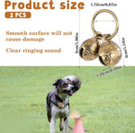 Four pieces of mini brass pet collar tracking bells arranged on a white background.
