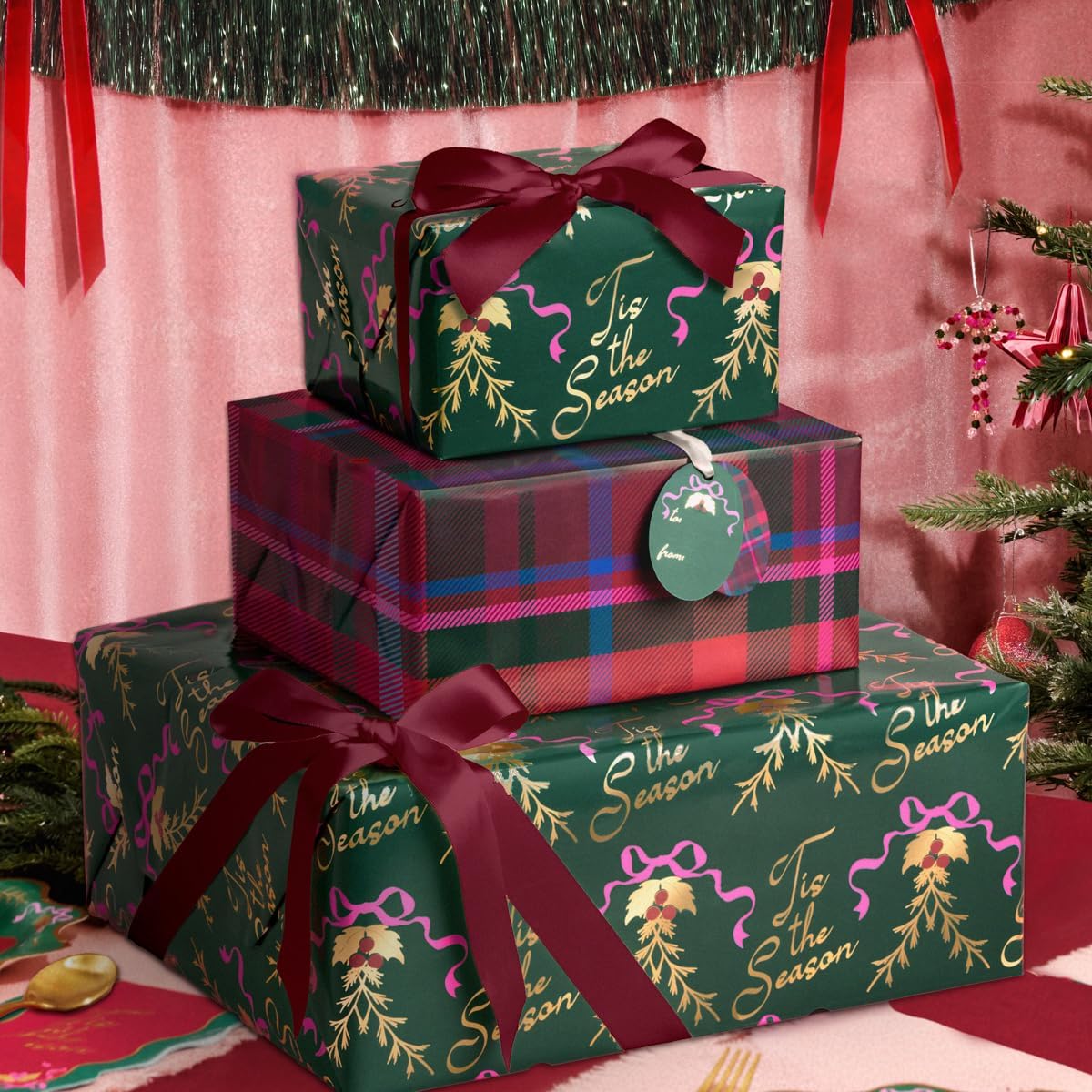 xo, Fetti Tis The Season wrapping paper front view showcasing festive holiday designs.