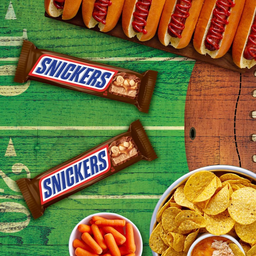 Snickers full size individually wrapped chocolate bars stacked together