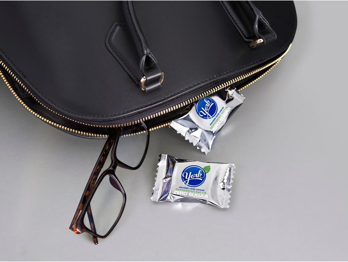 YORK zero sugar candy bag held to show the authentic import packaging size and weight details clearly.