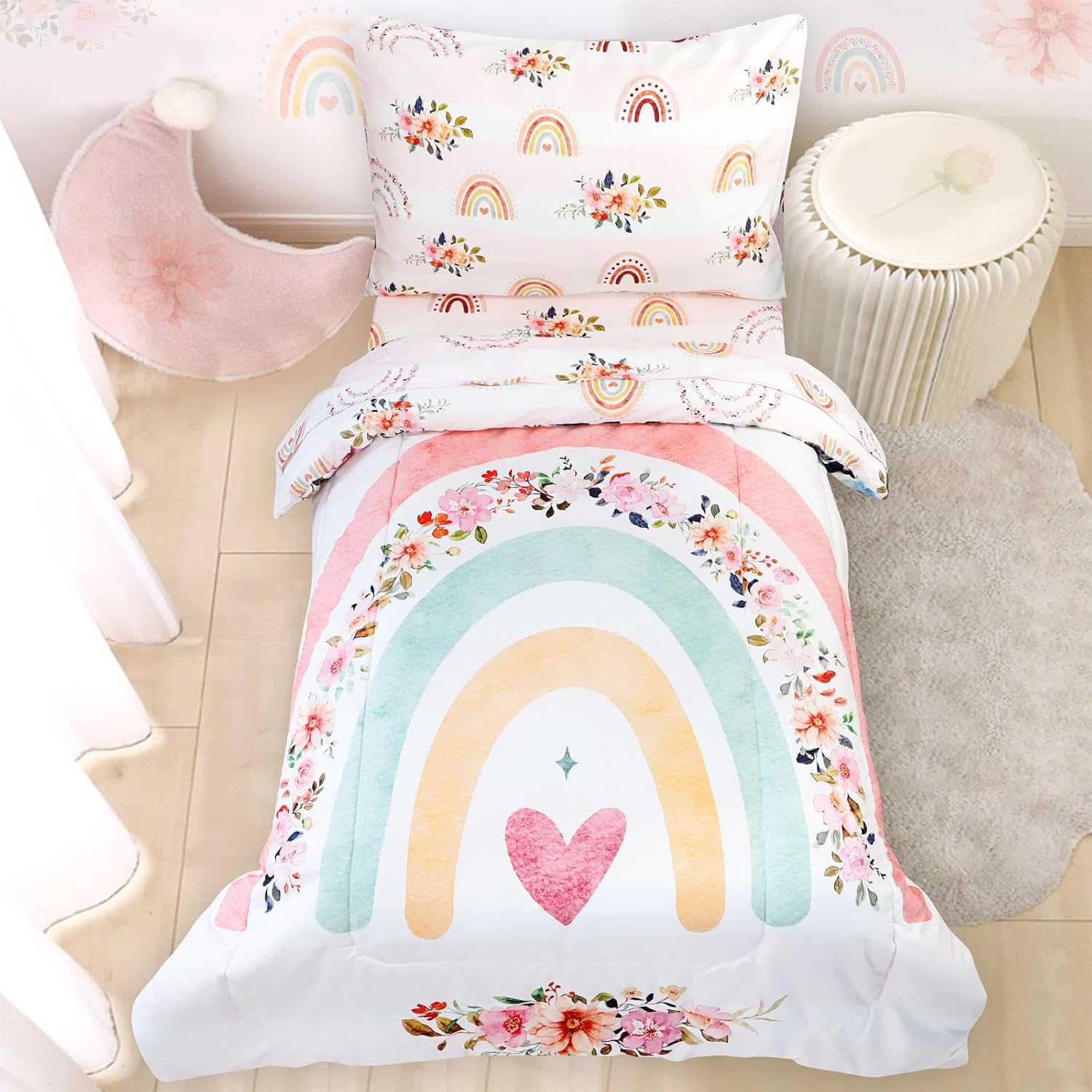 Pea Pod toddler bedding set for girls front view showcasing the pink floral and rainbow comforter arranged on a crib