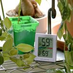 AcuRite digital thermometer placed on a wooden desk surface