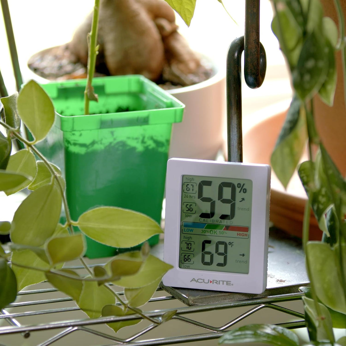 AcuRite digital thermometer placed on a wooden desk surface
