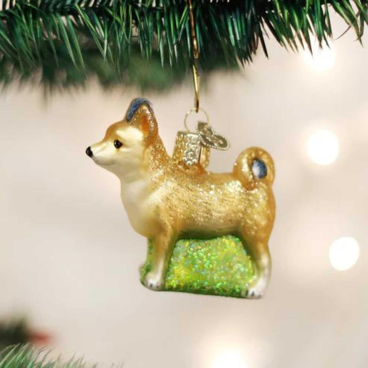 Rear view of the Chihuahua holiday decoration featuring the curled tail and golden tones.