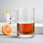 Viski crystal mixing beaker placed alongside classic cocktail glassware.
