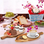 Acacia wood serving board placed on a modern dining table setting