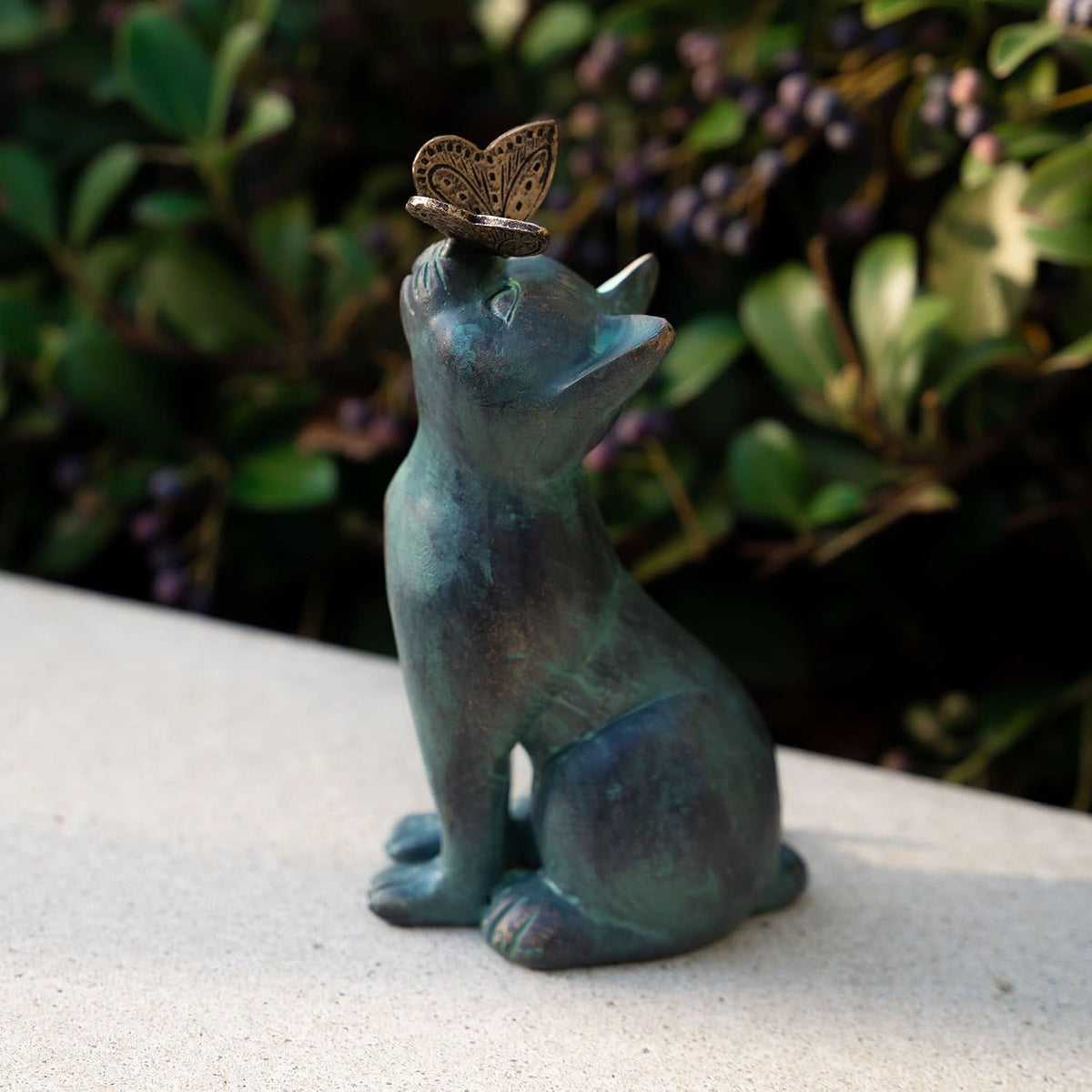 Detailed view of cat statue face and butterfly