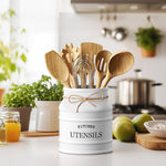 White farmhouse utensil crock counter organizer filled with wooden spatulas