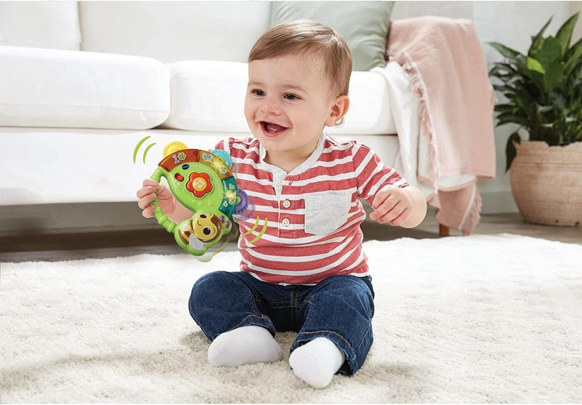 VTech musical tambourine showing light-up flower button and handle