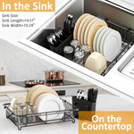 Stainless steel kitchen sink drainer with loaded plates and bowls