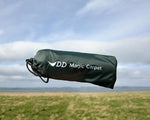 Olive green waterproof camping tarp deployed on grass