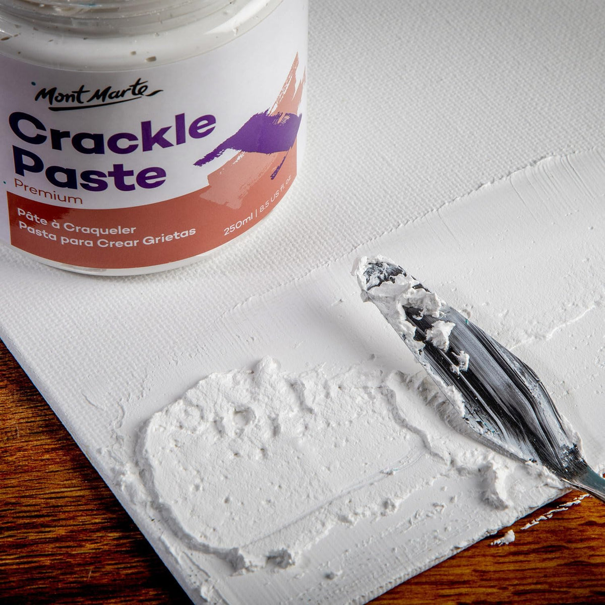 Artist applying crackle paste with a palette knife