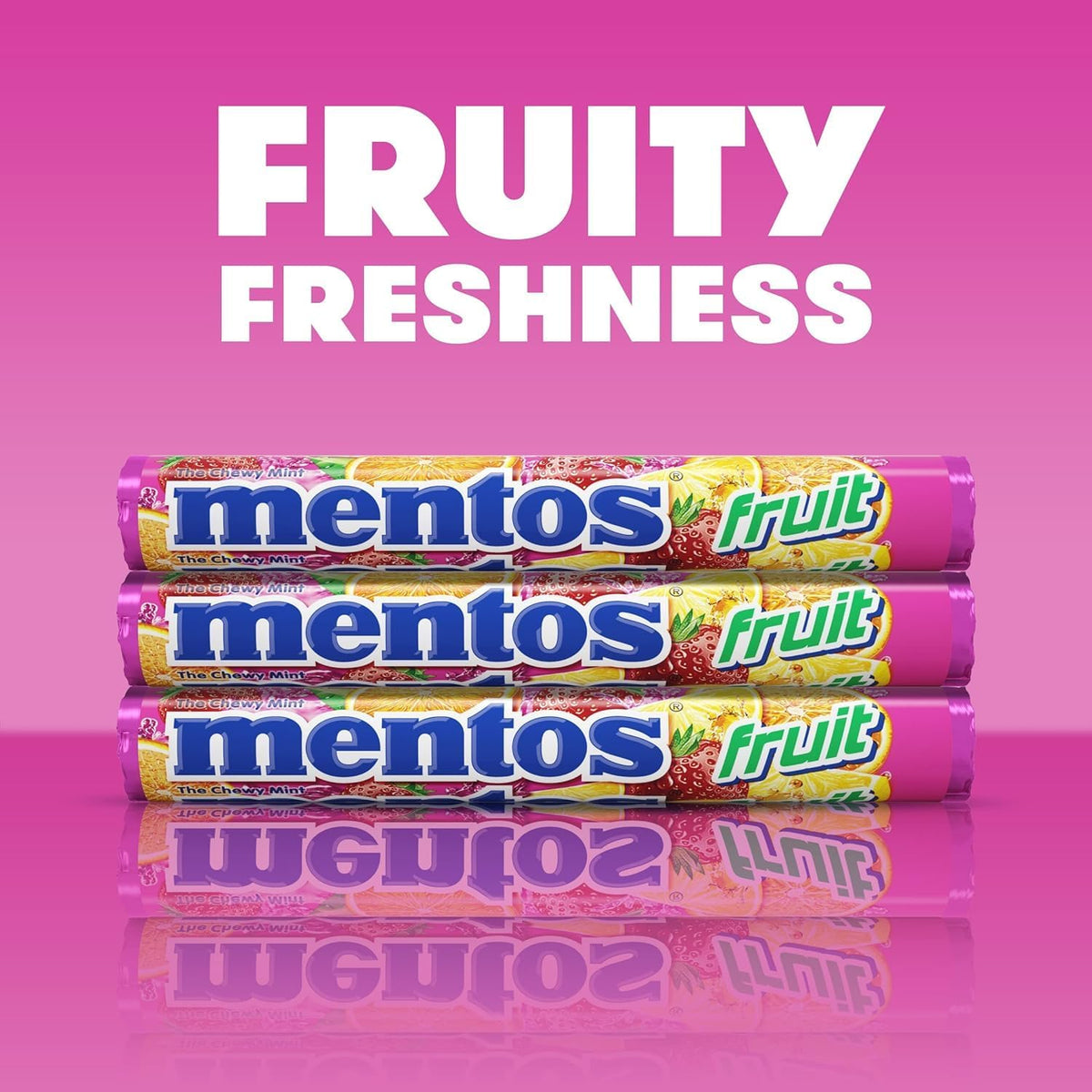 Close up of an open Mentos Fruit roll showing individual strawberry orange and lemon chewy pieces.