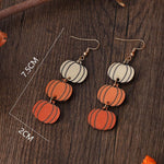 Pingyongchang autumn maple leaf and pumpkin earrings flat lay
