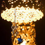 Decorative crystal pendant hanging on ceiling fan chain