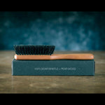 ZilberHaar beard brush displayed with grooming oils