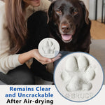 Two round and one heart shaped MYPAWLETS clay keepsakes displayed on plastic stands.
