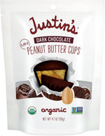 Close-up of a bite-sized Justin's mini cup showing the creamy peanut butter filling