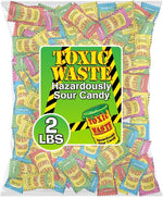 Top angle shot of authentic Toxic Waste sour sweets pile next to its official packaging pouch