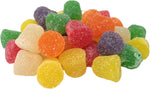 Textured shot of colorful holiday baking spice drops showing the sparkling crystalline sugar coating.