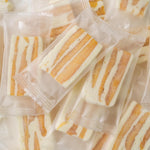 Individually wrapped GELUBOO snowflake pastry pieces arranged on a table.