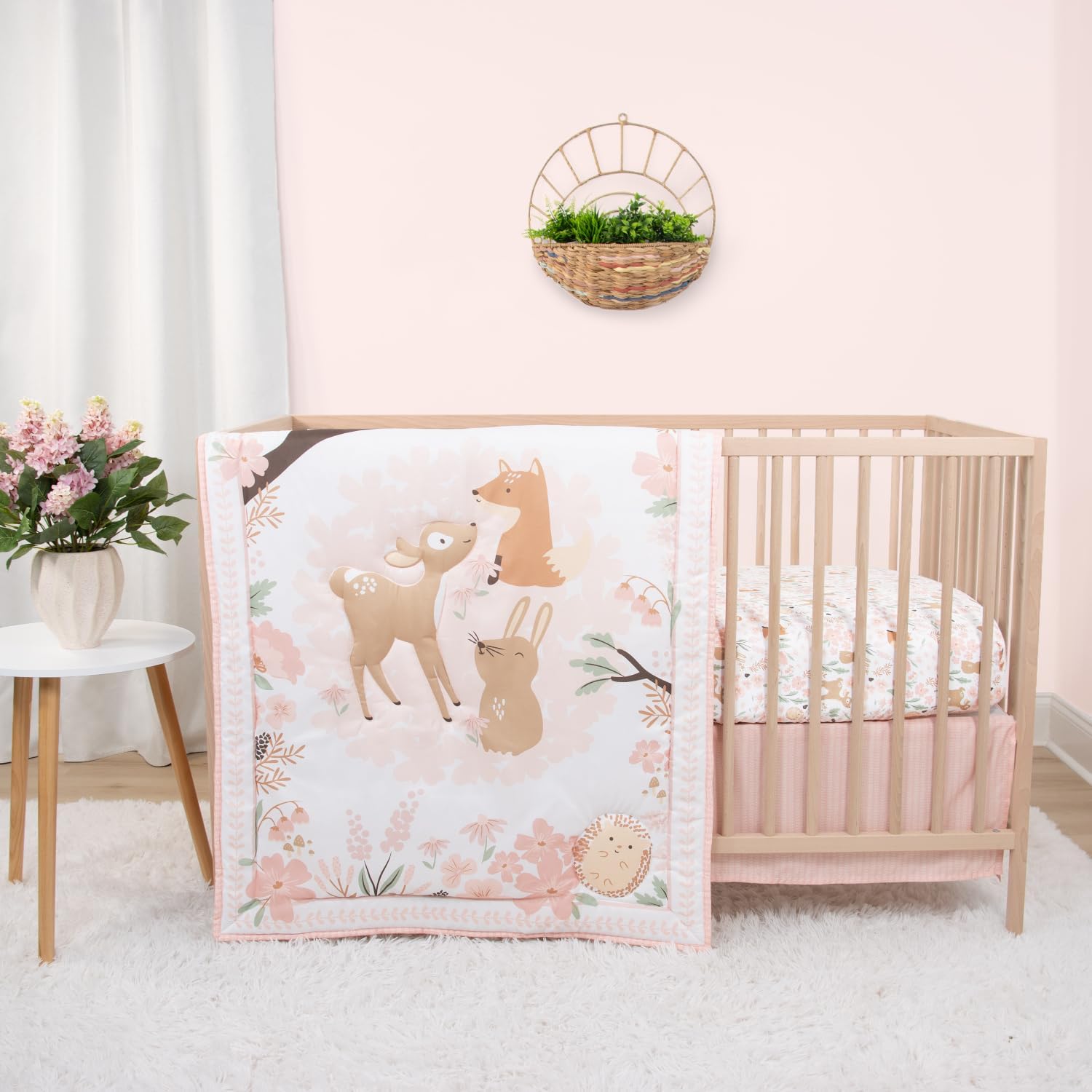 The Peanutshell Fairytale Forest crib bedding set front view showcasing the pink woodland animal quilt