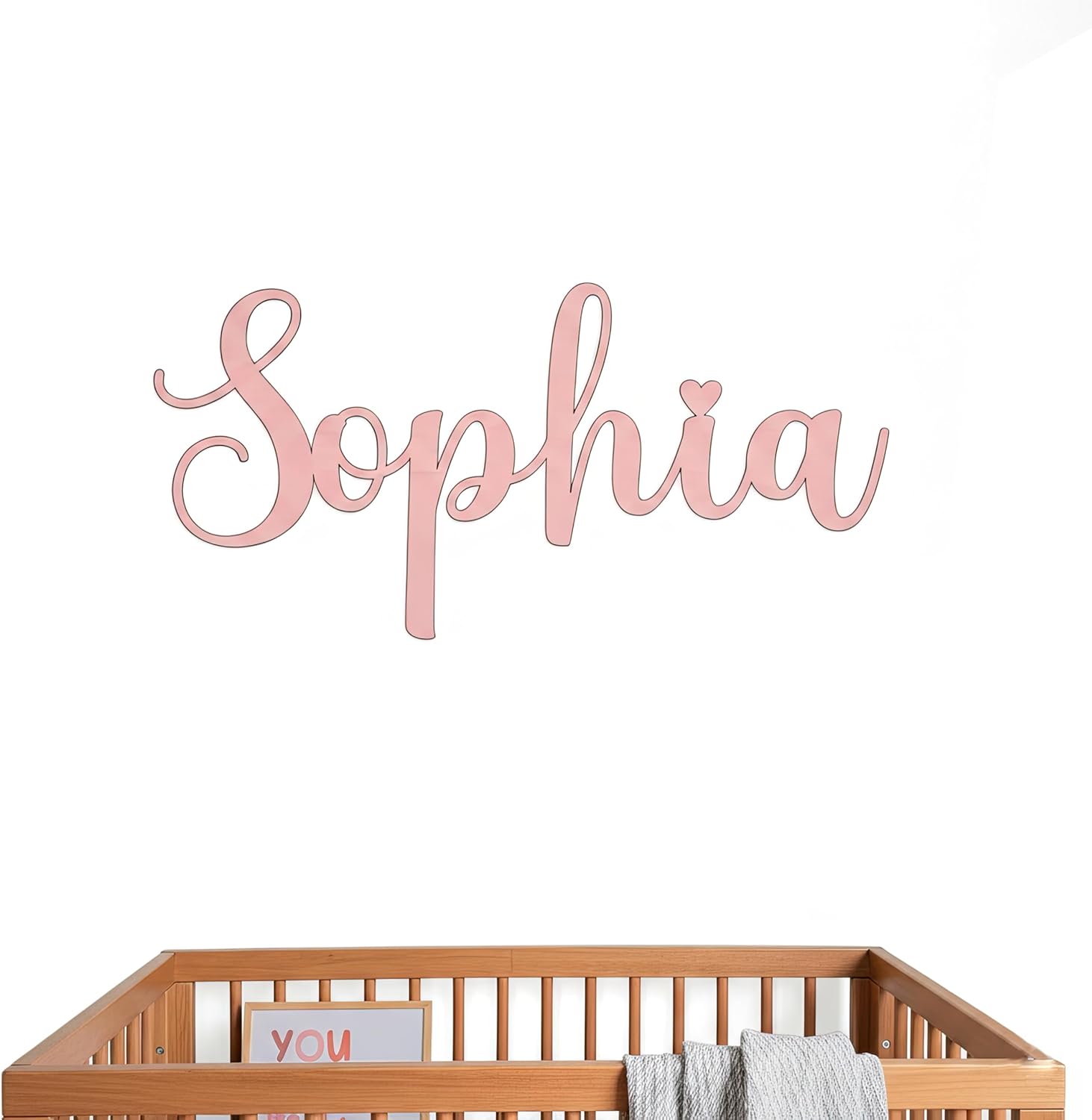 Handmade custom wood nursery name sign front view displaying elegant pink calligraphy lettering.