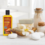 Jojoba oil bottle displayed next to fresh jojoba seeds