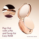 Luxury matte face powder compact being applied with a professional makeup brush.