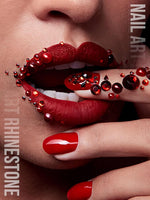 Assorted sizes of round red glass nail rhinestones in individual grid compartments.